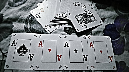 four Ace cards on floral sheet thumbnail