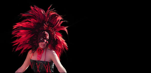 woman wearing a red headdress in a dark area thumbnail