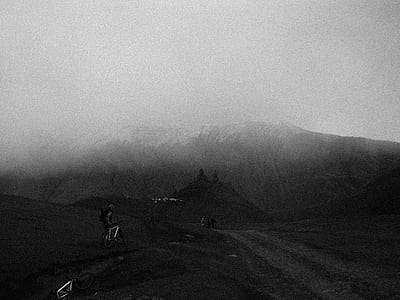 person with mountain bike standing near rock formation thumbnail