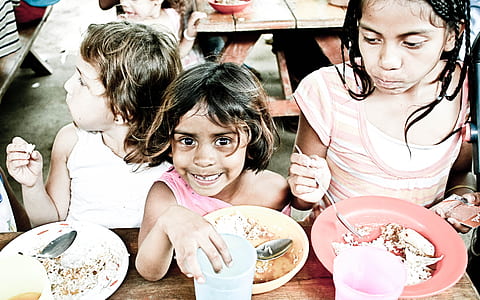 three child eating on table thumbnail