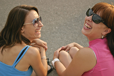 women wearing black sunglasses while smiling thumbnail