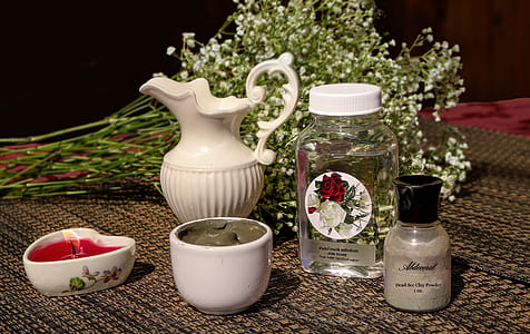 white ceramic pitcher beside clear glass jar with clear liquid inside thumbnail