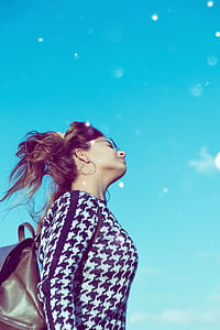 woman wearing sunglasses under blue sky thumbnail