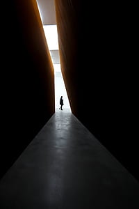 silhouette photo of person standing near wall thumbnail