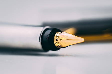 Selective Focus Photography of Fountain Pen on White Surface thumbnail