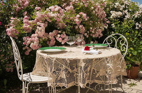 round white table with beige lace table mat at daytime thumbnail