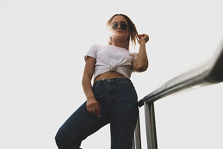 woman standing beside gray steel rails thumbnail
