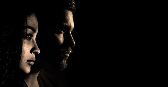 woman and man's faces on black background thumbnail
