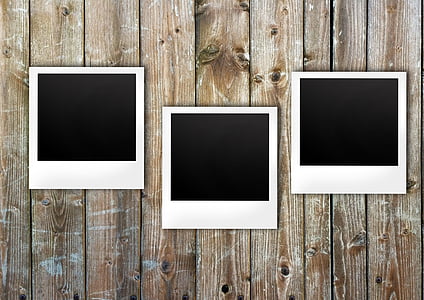 three white wooden frames on wall thumbnail