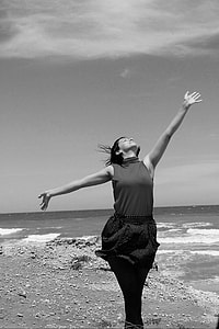 woman in dress near body of water in grayscale photography thumbnail