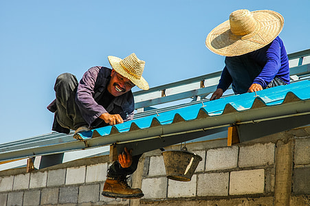 smiling man repairing roof during daytime thumbnail