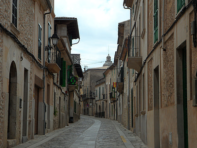 pathway between concrete buildings during day thumbnail