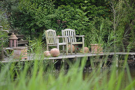 two brown wooden armchairs on wooden dock thumbnail