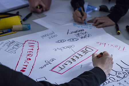 people writing on white paper thumbnail