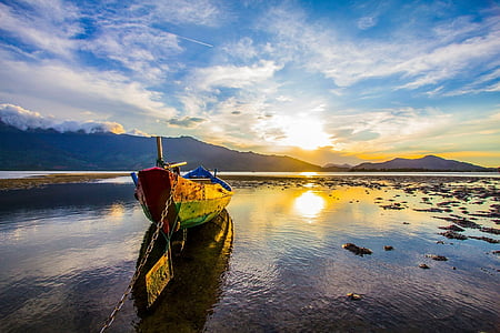 red and green canoe on body of water at daytime thumbnail