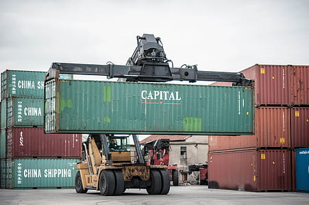 yellow intermodal lift lifting green Capital intermodal container at daytime thumbnail