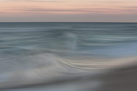 body of water under white and gray sky at golden hour thumbnail