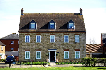 Brown Concrete House Near Black Car thumbnail