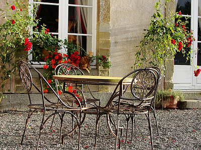 round black-and-brown metal bistro table set near the garden thumbnail