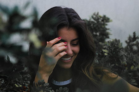 person holding her face near plants thumbnail