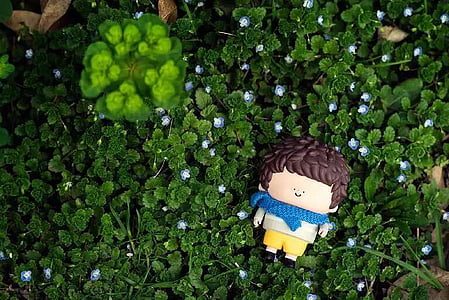boy plastic toy on green plant thumbnail