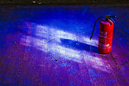 red and black fire extinguisher on floor thumbnail