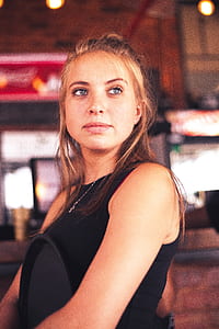 woman in black tank top looking far away thumbnail