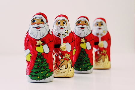 closeup photo of four Santa Claus matryoshka dolls thumbnail