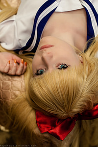 woman in white and blue sailor suit posing for a photo thumbnail