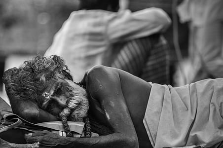 grayscale photography of lying topless man thumbnail
