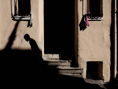 person standing near brown painted doorway thumbnail