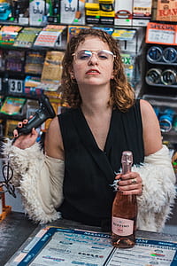 woman holds Ruffino rose wine bottle thumbnail