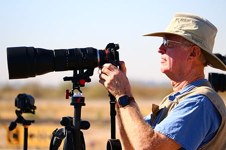 man holding camera taking picture thumbnail