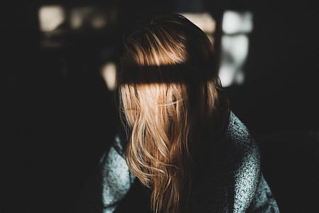 woman looking right in front of window inside room thumbnail