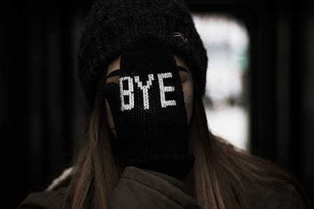 woman covering her face with black bye-printed glove thumbnail