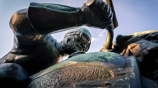 focus photography of man riding motorcycle statue thumbnail