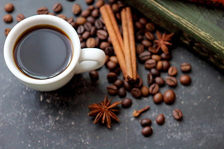 white ceramic coffee mug beside coffee beads thumbnail