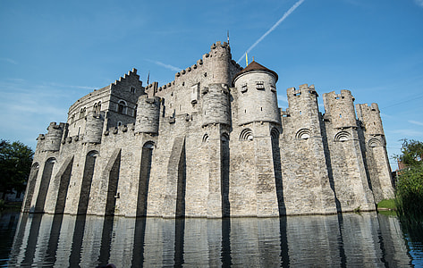 gray castle near body of water under blue sky at daytime thumbnail