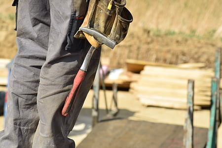 selective focus photography of man holding tool thumbnail