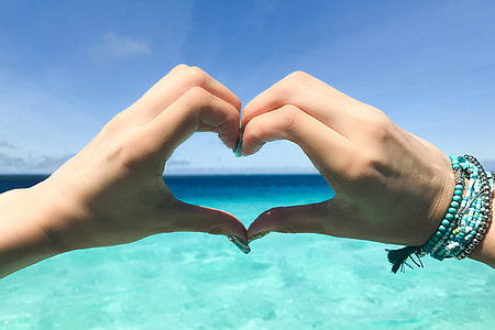 person doing a heart symbol using hands thumbnail