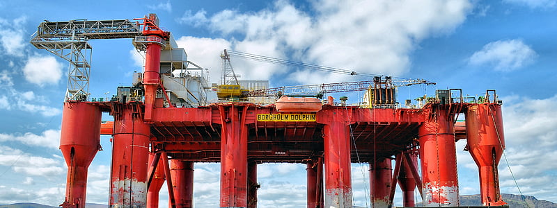 architectural photography of red oil rig thumbnail