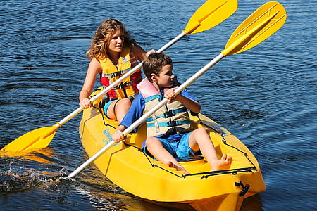 man and boy riding kayak thumbnail