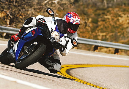 man riding sports bike on road at daytime thumbnail