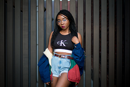 woman wearing black and white Calvin Klein crop shirt and blue denim shorts thumbnail