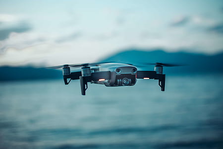 selective focus photography of a flying gray quadcopter drone thumbnail