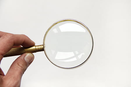 person holding magnifying glass thumbnail