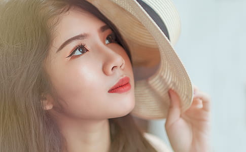 Woman Holding White Hat thumbnail