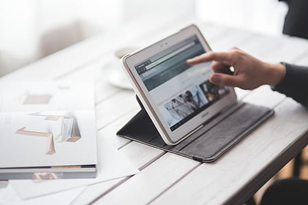 Man touching a digital tablet thumbnail