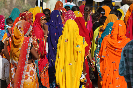 women wearing assorted-color sari while walking during daytime thumbnail