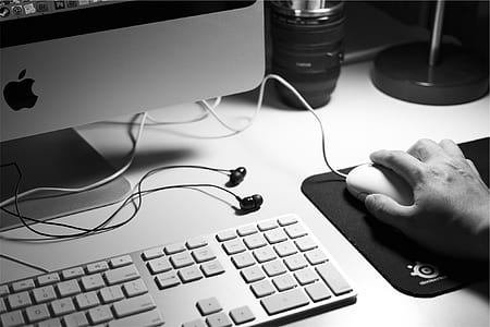 grayscale photo of person holding computer mouse thumbnail